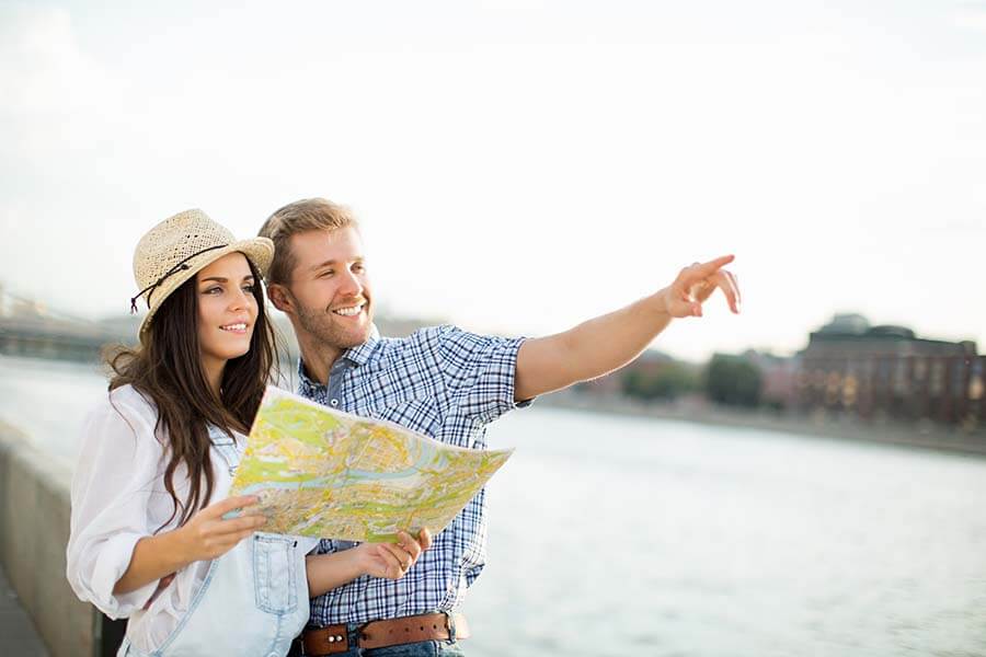 Image of young couple with a map - sightseeing on arrival