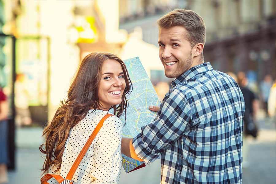 Image of young couple with a map - sightseeing on departure